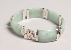 A CHINESE SILVER AND JADE BRACELET.