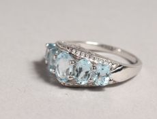 A SILVER FIVE STONE AQUAMARINE RING.