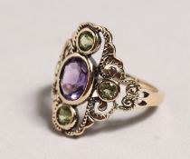 A 9CT GOLD, PERIDOT AND AMETHYST RING.