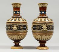 A PAIR OF METTLACH POTTERY VASES, one AF. 9ins