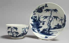 AN 18TH CENTURY WORCESTER TEA BOWL AND SAUCER painted with a willow tree and a house on an island.