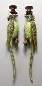 A PAIR OF PORCELAIN PARROT WALL SCONCES, with ormolu mounts. 18ins long.