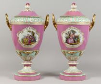 A GOOD PAIR OF 19TH CENTURY BERLIN PORCELAIN TWO HANDLED URNS AND COVERS, rose pompadour ground