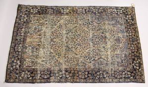A PERSIAN KERMAN CARPET, cream ground with stylised tree design. 7ft x 4ft 5ins.