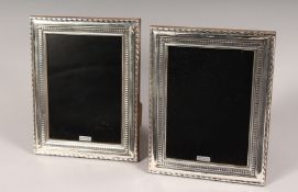 A PAIR OF SILVER UPRIGHT PHOTOGRAPH FRAMES. Bead Edge design. 8.5ins x 6.5ins.