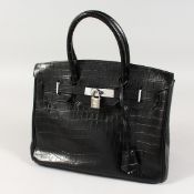 A BLACK LEATHER HANDBAG. 12ins x 9ins.