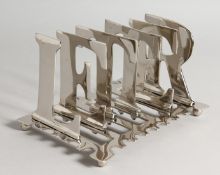A SILVER PLATE LETTER TOAST RACK.