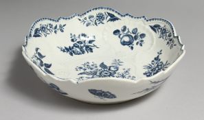 AN 18TH CENTURY WORCESTER JUNKET DISH OR SALAD BOWL, decorated with fruit, vegetables, moths, a