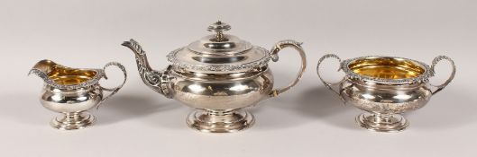 A GEORGE IV SCOTTISH SILVER THREE PIECE TEA SET, with cast shell and scroll sides, teapot, sugar