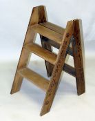 A WOODEN CHAMPAGNE FOLDING LADDER 2ft 8ins.