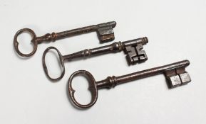 THREE 18TH / 19TH CENTURY CAST IRON KEYS. Largest: 6.25ins long.