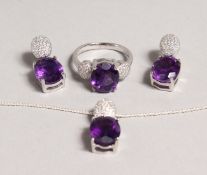 A SILVER AMETHYST SET RING and EARRINGS.