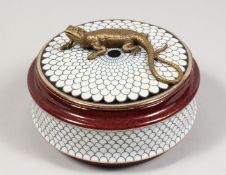 A PORCELAIN BOX AND COVER, the top with a bronze lizard. 5ins diameter.