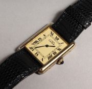 A CARTIER SILVER GILT WRISTWATCH, No. 170837, with leather strap, in a Cartier pouch.