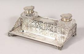 A GOOD VICTORIAN SILVER PIERCED TWO BOTTLE INKSTAND. London 1891. Maker: George Fox. 7.75ins long.