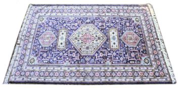 A PERSIAN CARPET, blue ground with a central large cream ground medallion. 8ft 6ins x 6ft 0ins.