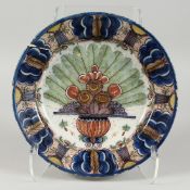 A LARGE DELFT TIN GLAZED CIRCULAR PLATE with flowers 12ins diameter.