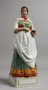 A LARGE COPENHAGEN PORCELAIN FIGURE OF A WOMAN holding a pestle and mortar. Inscribed HEDEBO.