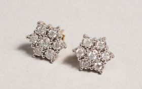 A GOOD PAIR OF 9CT GOLD AND DIAMOND CLUSTER EARRINGS.