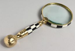 A NOVELTY MAGNIFYING GLASS with chequered and gilt handle.