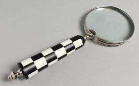 A NOVELTY MAGNIFYING GLASS with chequered handle.