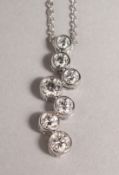 AN 18CT WHITE GOLD DIAMOND BUBBLE PENDANT on a chain.