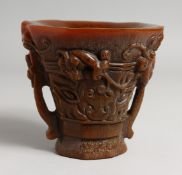 A CHINESE CARVED HORN LIBATION CUP. 5ins high.