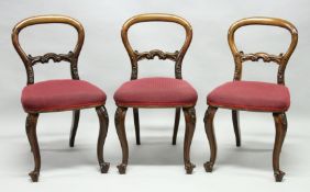 A SET OF THREE VICTORIAN MAHOGANY NAVAL DINING CHAIRS, each with removable legs, balloon backs,