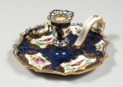 A SMALL BOOTH'S CHAMBER STICK painted with panels of flowers and birch 4.5ins high.