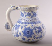 A TURKISH OTTOMAN IZNIK BLUE AND WHITE MASRAPA WATER JUG, painted with scrolling foliate decoration,
