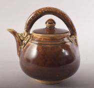 A SMALL CHINESE TREACLE GLAZE TEAPOT, with a chilong type handle, 13.5cm high.