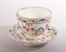A TURKISH KUTAHYA CUP AND SAUCER, with decorative foliate design, cup 9cm diameter, saucer 13,5cm