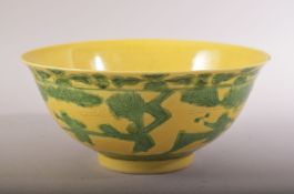 A CHINESE YELLOW GROUND PORCELAIN BOWL, with incised and green highlighted decoration depicting boys