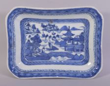 A CHINESE BLUE AND WHITE RECTANGULAR PORCELAIN DISH, the centre painted with a landscape setting,