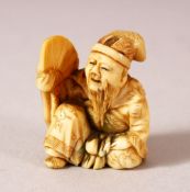 A JAPANESE MEIJI PERIOD CARVED IVORY NETSUKE - SEATED MAN - carved depicting a seated scholar or