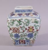 A CHINESE MING STYLE SQUARE FORM DOUCAI JAR, painted with precious objects and scrolling vines,