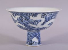 A CHINESE BLUE AND WHITE PORCELAIN STEM CUP, the exterior of the bowl painted with silhouettes of