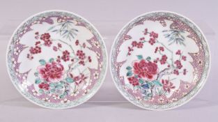 A SMALL PAIR OF CHINESE FAMILLE ROSE DISHES / SAUCERS, both painted with flowers, 13.5cm diameter.