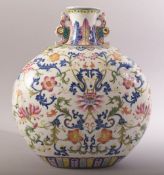 A CHINESE FAMILLE ROSE PORCELAIN TWIN HANDLE MOON FLASK, painted with an array of flowers and