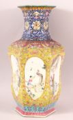 A CHINESE FAMILLE ROSE / FAMILLE JAUNE HEXAGONAL PORCELAIN VASE, painted with six oval panels