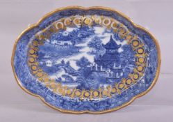 A CHINESE BLUE AND WHITE PORCELAIN TRAY, painted with a river landscape including buildings, figures