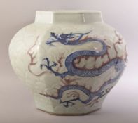 A CHINESE MING STYLE CELADON & IRON RED CARVED PORCELAIN JAR - decorated with scenes of dragons upon