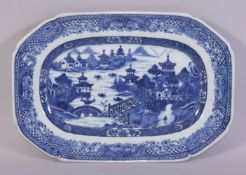 A CHINESE BLUE AND WHITE RECTANGULAR PORCELAIN DISH, the centre painted with a river landscape