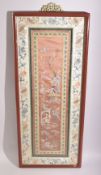 A 19TH CENTURY CHINESE EMBROIDERED SILK PANEL, framed and glazed, 69.5cm x 29cm.