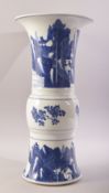 A CHINESE BLUE AND WHITE PORCELAIN GU SHAPE VASE, painted with villiage scenes on a lake with