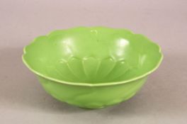 A CHINESE GREEN GLAZED LOTUS FORMED PORCELAIN PETAL DISH - with moulded petal lower section - the