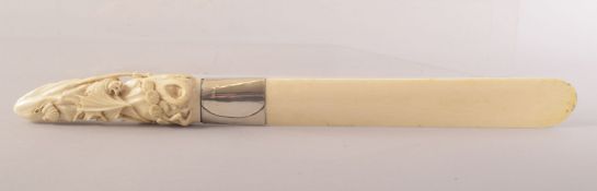 A CARVED IVORY LETTER OPENER, the handle carved with bats, the blade with metal mount, 37cm long.