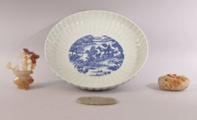 A MIXED LOT WITH A CHINESE BLUE AND WHITE RIBBED PORCELAIN DISH, together with a pierced jade