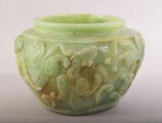 A SMALL CHINESE CARVED GREEN HARDSTONE BOWL / SHALLOW VASE, the body carved with chilong, 8.5cm