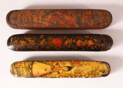 THREE 19TH CENTURY PERISAN QAJAR LACQUER PEN BOXES - QALAMDANS - each with varying painted